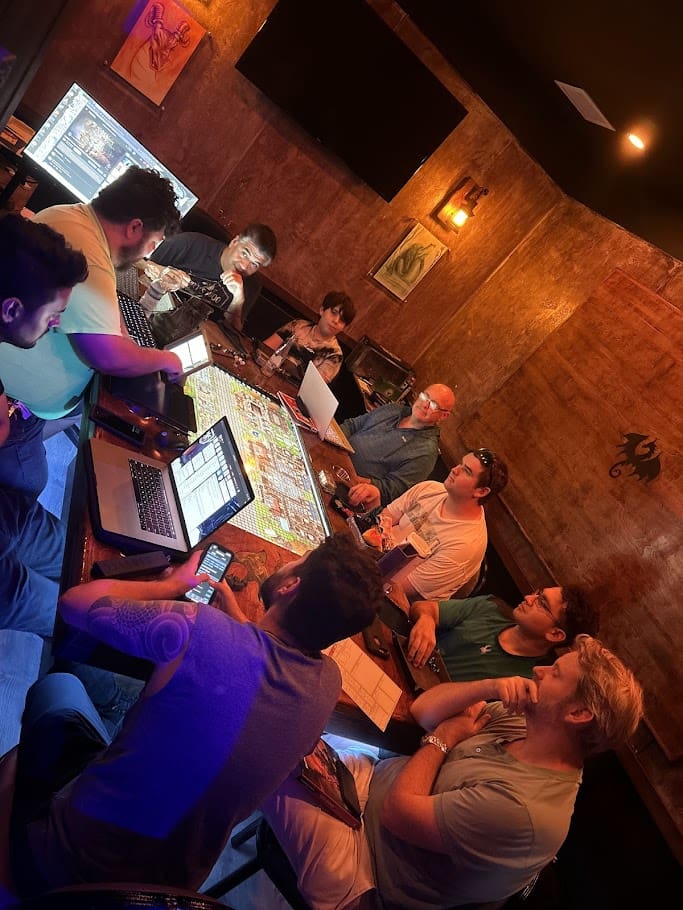 Group of players gathered around a D&D table at Skillshotz Gaming in Deerfield Beach during a corporate team building event